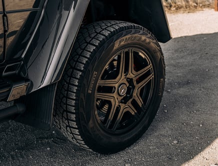 Close-up of a car wheel with Pirelli tire and a five-spoke alloy rim featuring a Mercedes logo.