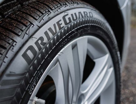 Close-up of a car tire with the word "DRIVEGUARD" embossed on the sidewall.