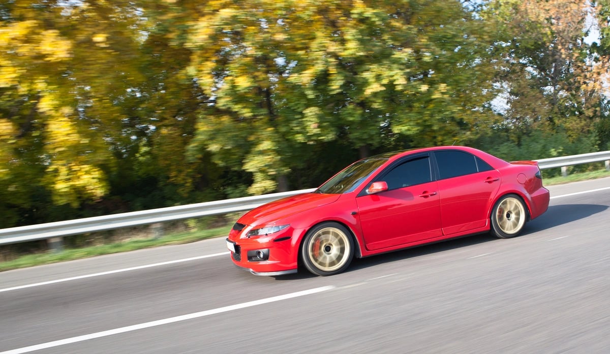 red sports car with low profile tires...