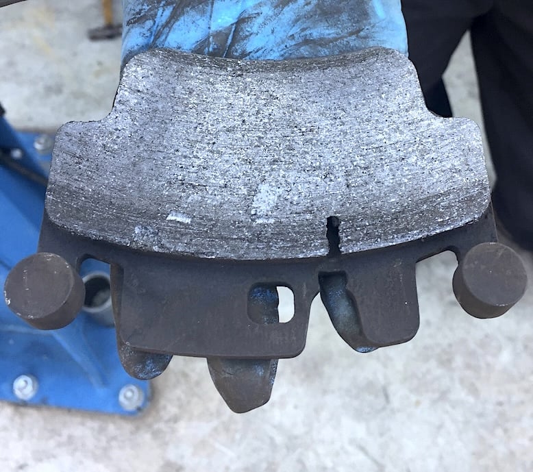 Worn brake pad after it's been removed from the vehicle.