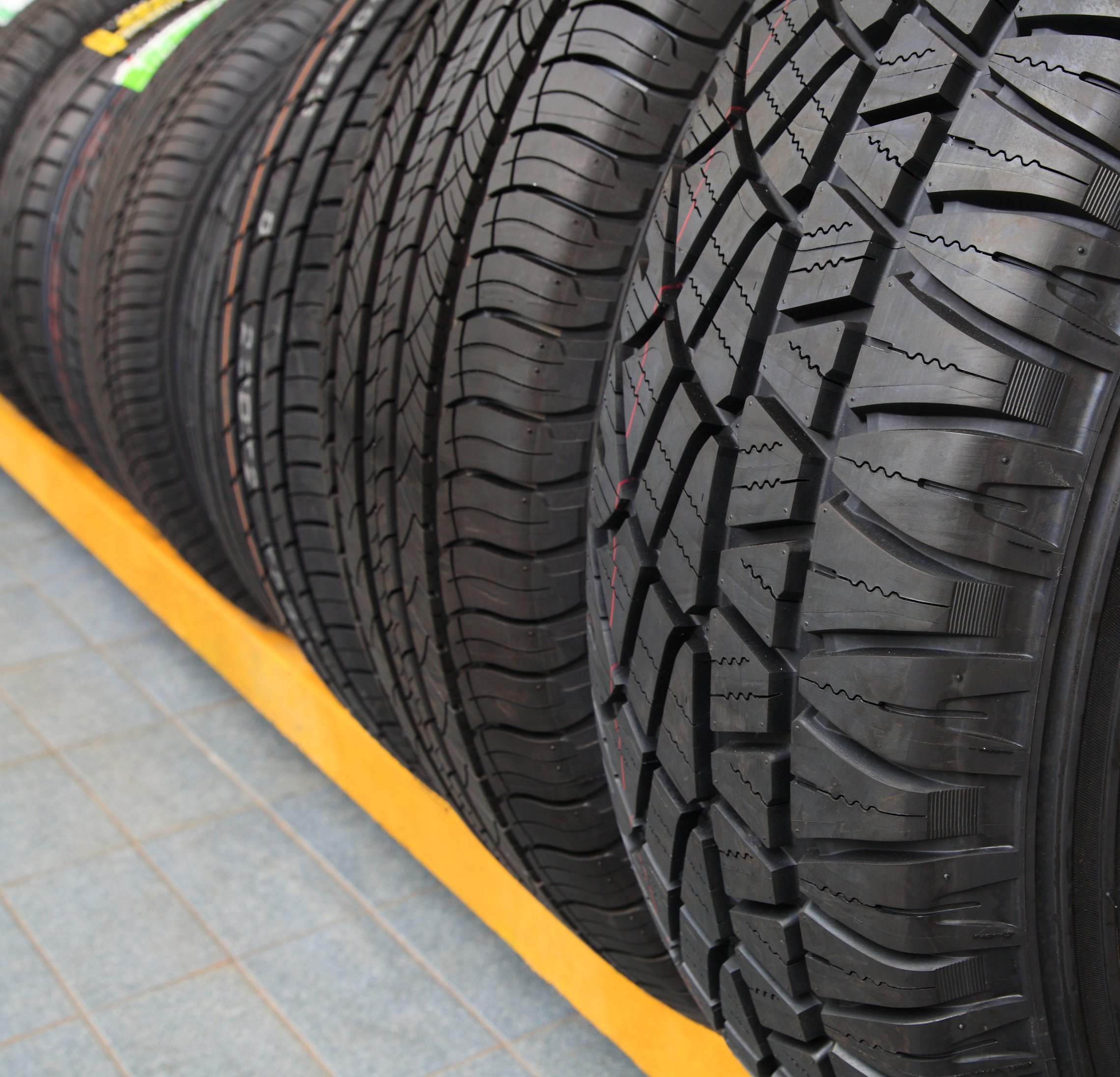 new tires in a rack at a store.jpeg