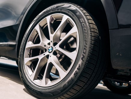 A close-up of a BMW wheel with a Pirelli Scorpion tire.